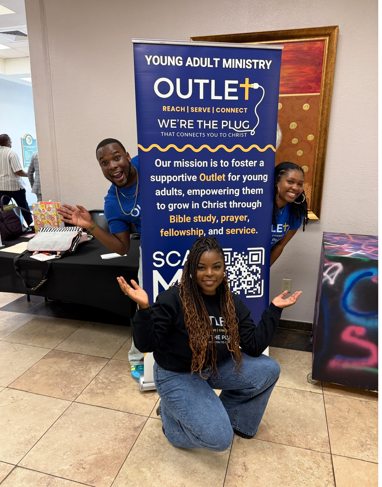 Outlet members at the Young Adult Ministry welcome table